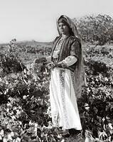 Palestinian woman from Ein Yabroud Ramallah carrying a bunch of grapes 1937